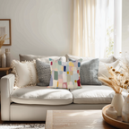 Living room with a beige sofa adorned with colorful pillows and decorative vases.